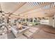 Outdoor kitchen with fire pit, grill, and pergola at 8320 Deer Springs Way, Las Vegas, NV 89149
