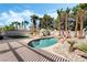 Backyard with a sparkling pool, rock features, and mature palm trees for a relaxing oasis at 8320 Deer Springs Way, Las Vegas, NV 89149
