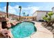 Beautiful swimming pool with a rock waterfall, palm trees, and manicured landscaping offering a tranquil backyard escape at 8320 Deer Springs Way, Las Vegas, NV 89149