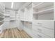 Well-organized walk-in closet with custom shelving, drawers, and ample storage space on wood floors at 8320 Deer Springs Way, Las Vegas, NV 89149