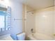 Bright bathroom featuring tub with shower and single sink vanity with mirrored cabinet at 8555 W Russell Rd # 2020, Las Vegas, NV 89113