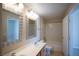 Bright bathroom with double sink vanity, framed mirrors, tub with shower, and tiled floor at 8555 W Russell Rd # 2020, Las Vegas, NV 89113