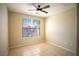 Neutral-toned bedroom features tile flooring, a ceiling fan, and a sun-filled window at 8555 W Russell Rd # 2020, Las Vegas, NV 89113