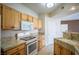 Well-lit kitchen featuring light wood cabinets, granite countertops, and modern appliances at 8555 W Russell Rd # 2020, Las Vegas, NV 89113