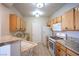 Charming kitchen featuring wooden cabinets, modern appliances and tiled floors at 8555 W Russell Rd # 2020, Las Vegas, NV 89113