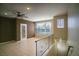 Bright and airy living room featuring tile floors, a stylish door, and a modern ceiling fan at 8555 W Russell Rd # 2020, Las Vegas, NV 89113