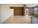 Bright and airy living room featuring tile floors, a stylish door, and a modern ceiling fan at 8555 W Russell Rd # 2020, Las Vegas, NV 89113
