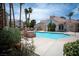 Community pool area with lounge chairs and lush greenery at 8555 W Russell Rd # 2020, Las Vegas, NV 89113