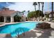 Community pool with lounge chairs and lush landscaping at 8555 W Russell Rd # 2020, Las Vegas, NV 89113