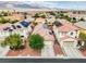Aerial view of homes with solar panels and mature landscaping, set against a mountain backdrop at 8836 Martin Downs Pl, Las Vegas, NV 89131
