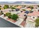 Aerial view of homes in the neighborhood, many with solar panels, and manicured desert landscaping at 8836 Martin Downs Pl, Las Vegas, NV 89131