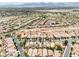 Extensive aerial view showcases a sprawling residential community against a backdrop of desert and mountain views at 8836 Martin Downs Pl, Las Vegas, NV 89131