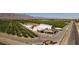 Aerial view showcases the Gilcrease Orchard layout, including crop rows, buildings, and road access at 8836 Martin Downs Pl, Las Vegas, NV 89131
