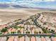 Stunning aerial view of a residential neighborhood, featuring well-maintained homes and a beautiful desert and mountain backdrop at 8836 Martin Downs Pl, Las Vegas, NV 89131