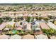High aerial view of a neighborhood featuring homes with solar panels, pools, and well-maintained landscaping at 8836 Martin Downs Pl, Las Vegas, NV 89131