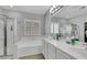 Bright bathroom with double vanity, stand-up shower, tub, and lots of natural light at 8836 Martin Downs Pl, Las Vegas, NV 89131