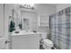 Bright bathroom featuring a white vanity, framed mirror and tub-shower combo with patterned curtain at 8836 Martin Downs Pl, Las Vegas, NV 89131
