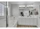 Beautiful bathroom with double vanity, stand-up shower, tub, and modern lighting at 8836 Martin Downs Pl, Las Vegas, NV 89131