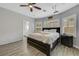 Bright bedroom with a king bed, ceiling fan, hardwood floors, and ensuite bathroom at 8836 Martin Downs Pl, Las Vegas, NV 89131
