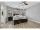 Comfortable bedroom features a ceiling fan, neutral color scheme, hardwood floors, and natural light at 8836 Martin Downs Pl, Las Vegas, NV 89131