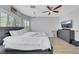 This bedroom features hardwood floors, a ceiling fan, TV, and lots of natural light at 8836 Martin Downs Pl, Las Vegas, NV 89131