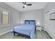 Cozy bedroom features a ceiling fan, sliding closet doors, and a window at 8836 Martin Downs Pl, Las Vegas, NV 89131