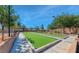 Enjoy a fun game of bocce ball on this well-maintained community court under a bright blue sky at 8836 Martin Downs Pl, Las Vegas, NV 89131