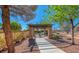 Relax in the community picnic area with pergola, featuring shaded seating and well-kept landscaping at 8836 Martin Downs Pl, Las Vegas, NV 89131