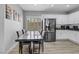 Bright dining area with modern table set, shuttered windows, and adjacent kitchen at 8836 Martin Downs Pl, Las Vegas, NV 89131