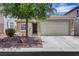 Charming single-story home with a well-maintained lawn, mature shade tree, and a two-car garage at 8836 Martin Downs Pl, Las Vegas, NV 89131