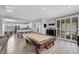 Bright game room includes a pool table, sliding glass doors, and an open floor plan to the kitchen at 8836 Martin Downs Pl, Las Vegas, NV 89131