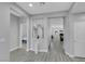 Hallway with gray flooring, white trim and doors. Arched doorway leads to a bedroom at 8836 Martin Downs Pl, Las Vegas, NV 89131