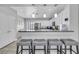 Open kitchen with breakfast bar, granite countertops, stainless steel appliances, and pendant lighting at 8836 Martin Downs Pl, Las Vegas, NV 89131