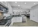 Modern kitchen showcasing stainless steel appliances, granite countertops, and light wood flooring at 8836 Martin Downs Pl, Las Vegas, NV 89131