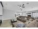 Open living room with a large sectional sofa, media setup, and an open floor plan at 8836 Martin Downs Pl, Las Vegas, NV 89131