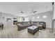 Spacious living room with comfortable sectional sofa, projector, and ceiling fan at 8836 Martin Downs Pl, Las Vegas, NV 89131