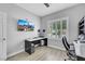 Bright office with a built in desk, ceiling fan, and a large window at 8836 Martin Downs Pl, Las Vegas, NV 89131