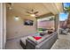 The covered patio features a ceiling fan, TV, and outdoor seating area at 8836 Martin Downs Pl, Las Vegas, NV 89131