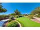 Practice your short game on this artificial putting green, surrounded by lush community landscaping at 8836 Martin Downs Pl, Las Vegas, NV 89131