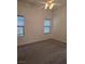 Cozy bedroom with neutral carpet, ceiling fan, and windows letting in light at 8985 S Durango Dr # 1154, Las Vegas, NV 89113