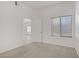 Neutral carpeted bedroom featuring a window with blinds and entry door at 8985 S Durango Dr # 1154, Las Vegas, NV 89113