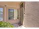 Front door and welcome mat outside the home, with a security gate and window at 8985 S Durango Dr # 1154, Las Vegas, NV 89113