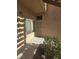 Exterior view of the unit's front door with security screen, and shade-covered entrance at 8985 S Durango Dr # 1154, Las Vegas, NV 89113