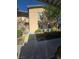 Building's exterior with sidewalks, stairways, and landscaping including mature tree and bushes at 8985 S Durango Dr # 1154, Las Vegas, NV 89113