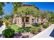 Building exterior with well-maintained landscaping, mature trees, and inviting walkway at 8985 S Durango Dr # 1154, Las Vegas, NV 89113