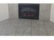 Close-up of a fireplace surrounded by stone tiles and gray tile floors at 8985 S Durango Dr # 1154, Las Vegas, NV 89113
