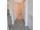 Hallway with access to a closet with wood shelving and neutral tile flooring at 8985 S Durango Dr # 1154, Las Vegas, NV 89113