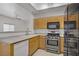 Kitchen with modern stainless steel appliances and a view into the living area at 8985 S Durango Dr # 1154, Las Vegas, NV 89113