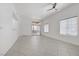Bright living room with tile flooring, ceiling fan, and sliding glass doors at 8985 S Durango Dr # 1154, Las Vegas, NV 89113