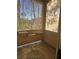 Enclosed patio with open-air screens and shelving for plants or decor at 8985 S Durango Dr # 1154, Las Vegas, NV 89113